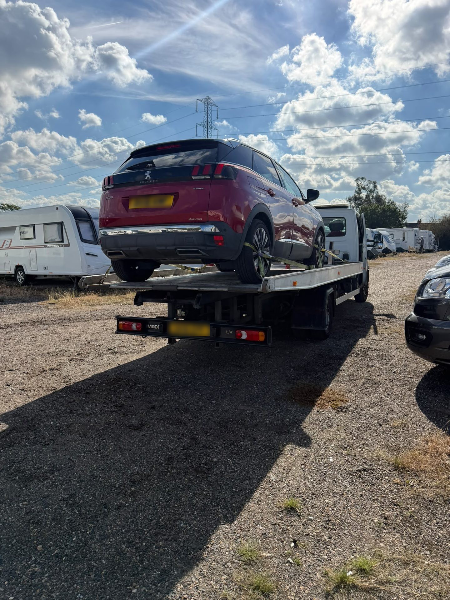 Car on an Instant Recovery flatbed truck during a vehicle recovery job in Essex