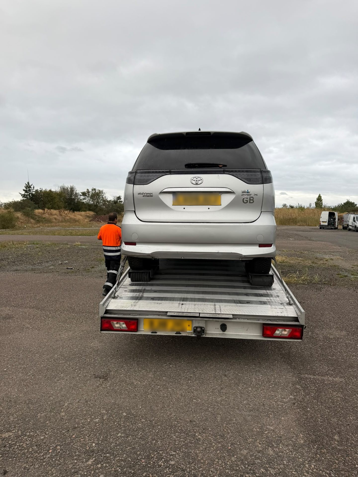 Silver Toyota MPV loaded on a flatbed recovery truck