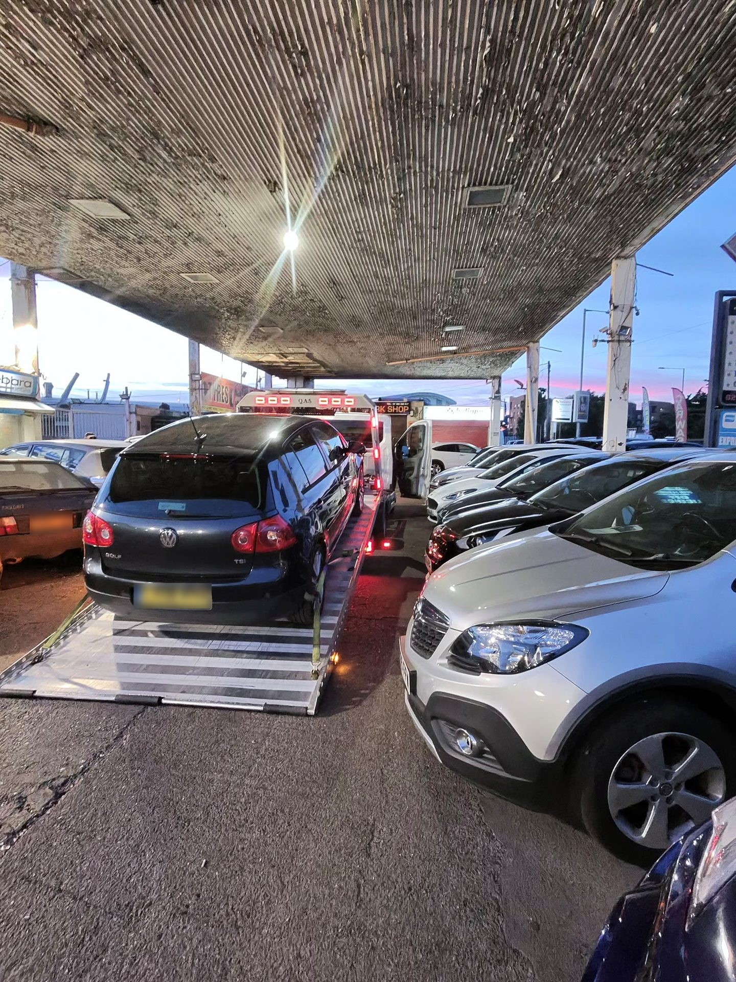 Car on an Instant Recovery flatbed truck during a vehicle recovery job in Ilford