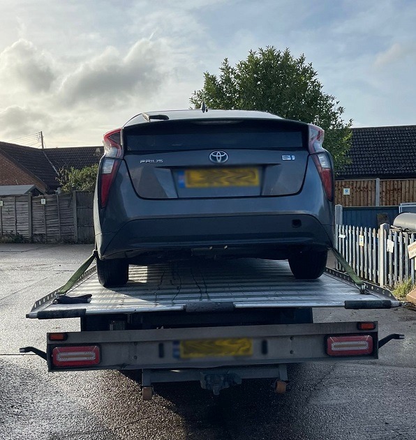 Car on an Instant Recovery flatbed truck during a vehicle recovery job in East London