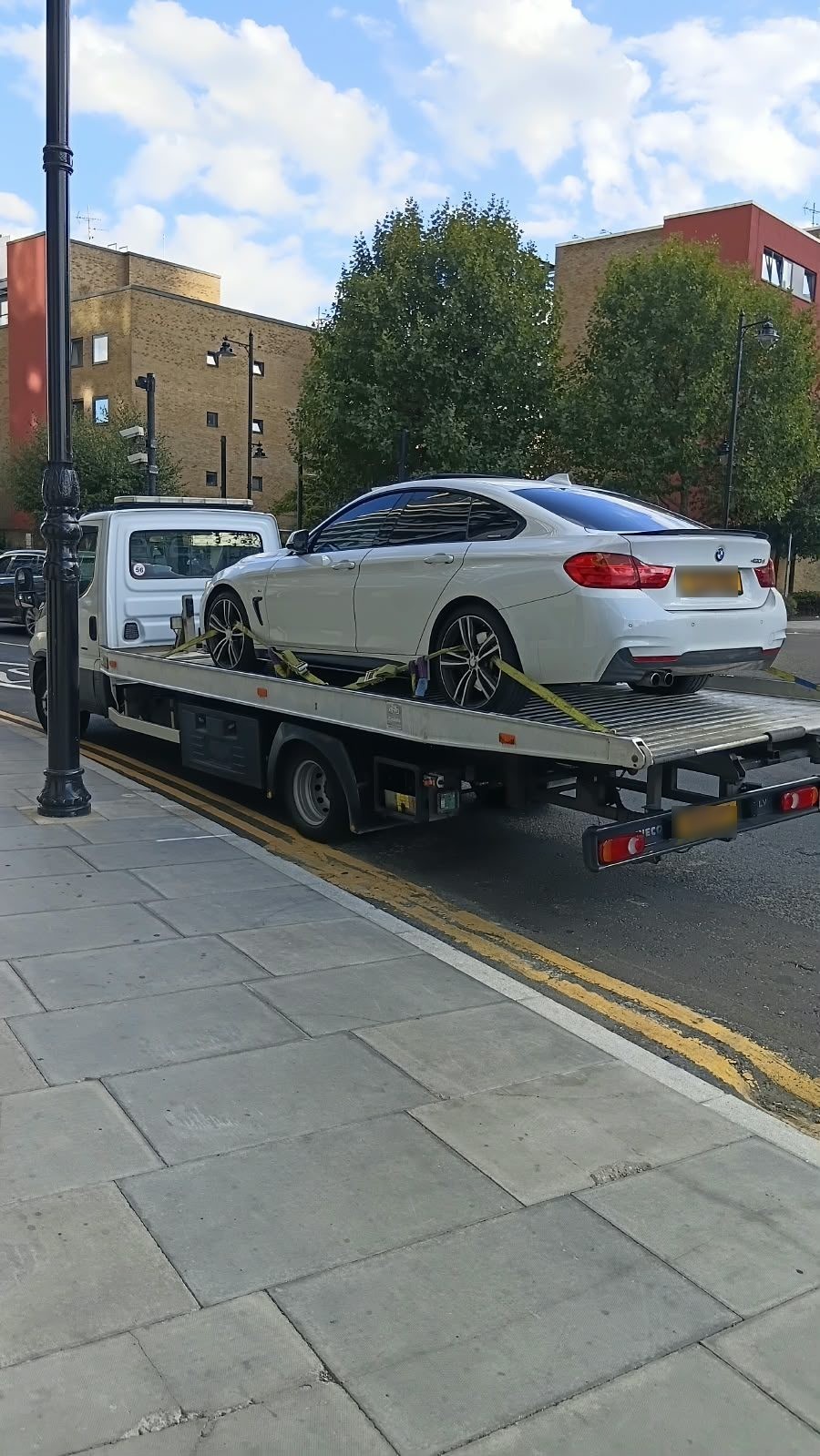 White BMW coupe on a recovery truck near me in East London